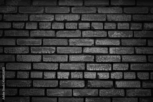 Black brick wall texture background. Black white grunge background. Old brick wall with cracks.