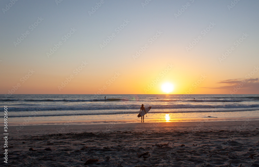 Wide View of Surfer Watching Crashing Waves on Sunset Beach Costa Rica