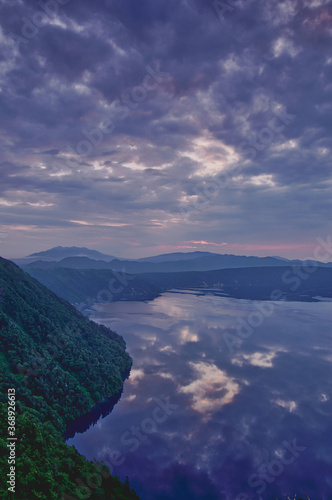 曇り空を湖面に映す夜明けの湖。摩周湖、北海道、日本。