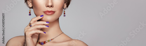Portrait Beautiful Woman with Jewelry. Model Girl with Violet Manicure on Nails. Elegant Hairstyle.  Beauty and Accessories