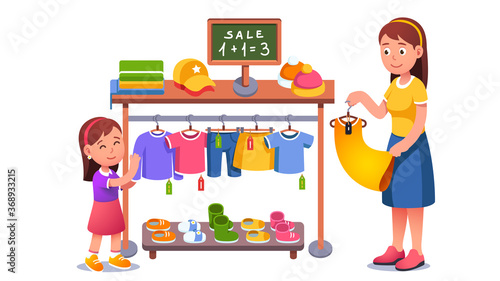 Mother and daughter kid choosing clothes at sale