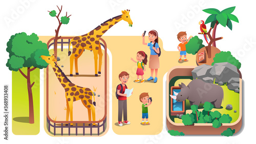 Girl, boys kids and parents taking photos in zoo
