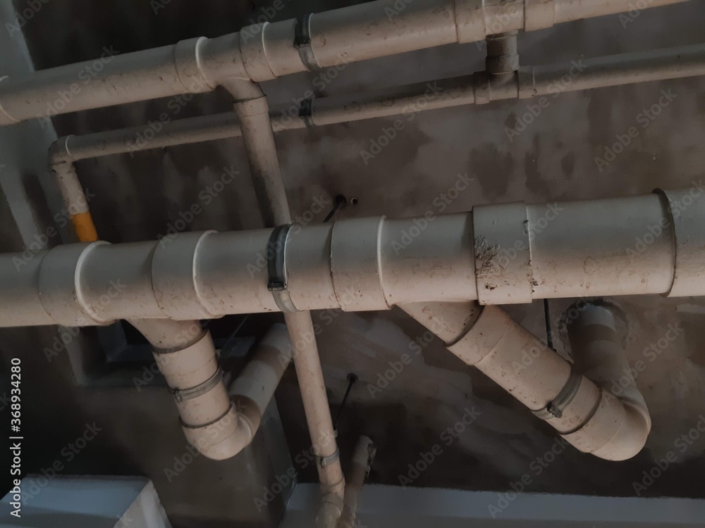 Pipes hanging from the ceiling inside industry building. Pipes hanging from the ceiling inside industry building.