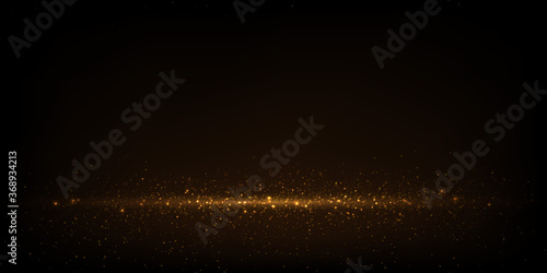 Gold bokeh lights, glowing glitter dust abstract luxury background	