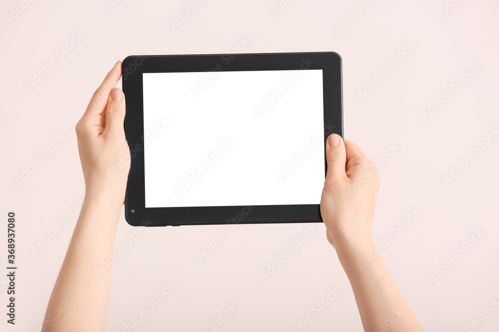 Hands with modern tablet computer on light background Hands with modern tablet computer on light background