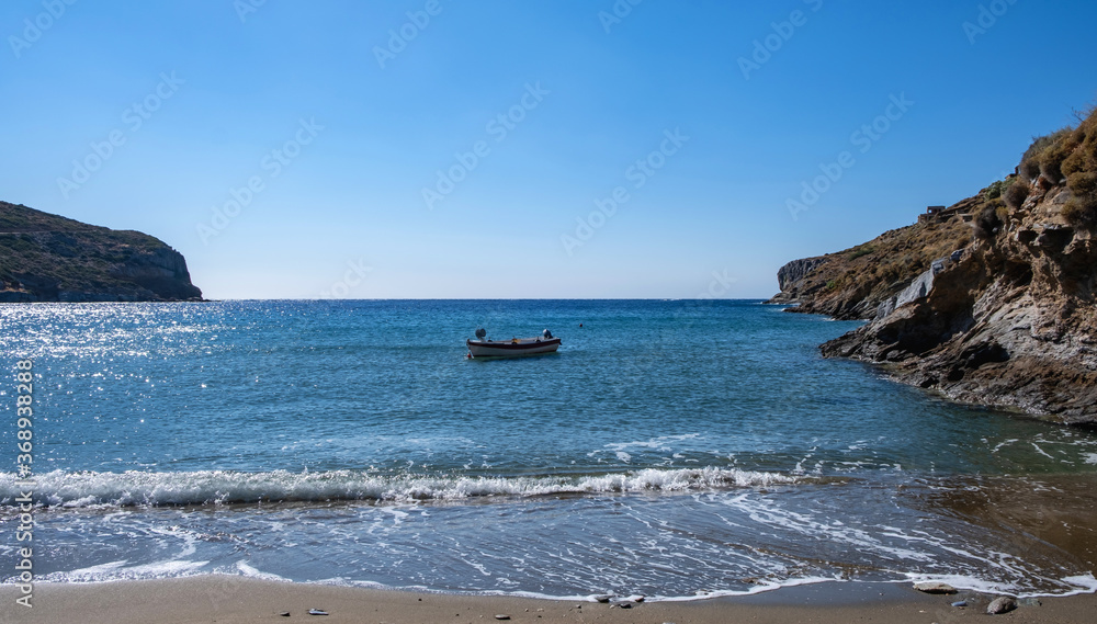 Small boat on the sea, blue clear sky, calm sea water and sandy beach background Small boat on the sea, blue clear sky, calm sea water and sandy beach background
