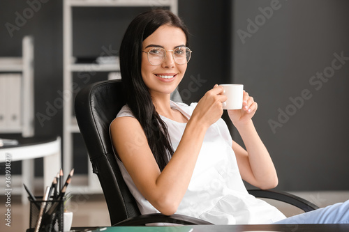 Young woman drinking coffee...