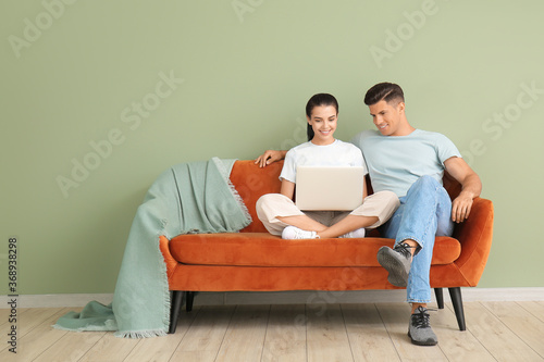 Young couple with laptop re...