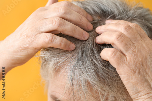 Senior woman touching her h...