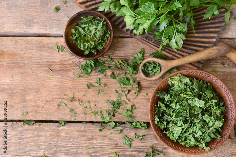 Bowls with dry parsley on table Bowls with dry parsley on table