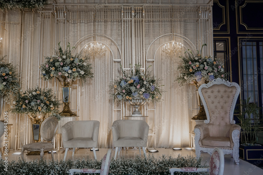 wedding stage decoration with fabric and flower bouquet. flower decoration on wedding backdrop