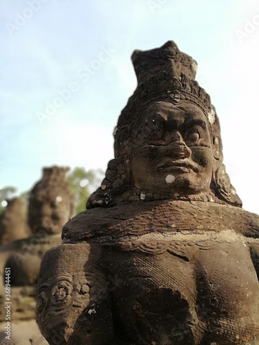 Statues of demons on the pathway to the south gate of Angkor Thom. 