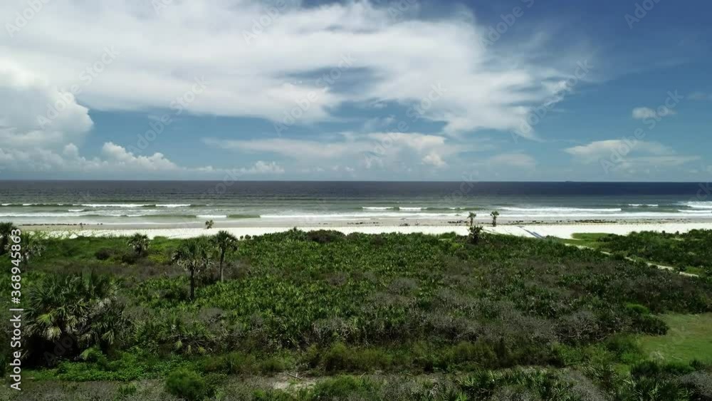 Rising aerial over the dunes and beach in Palm Coast, Florida. Rising aerial over the dunes and beach in Palm Coast, Florida.