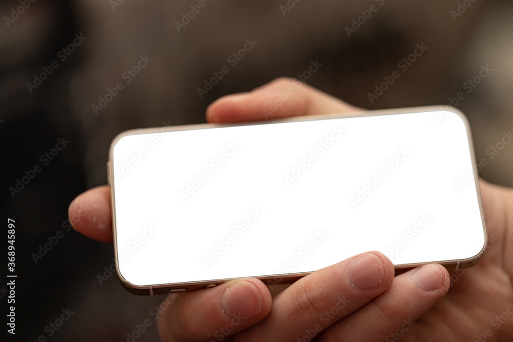 Closeup of male hand holding and using modern smart phone Closeup of male hand holding and using modern smart phone