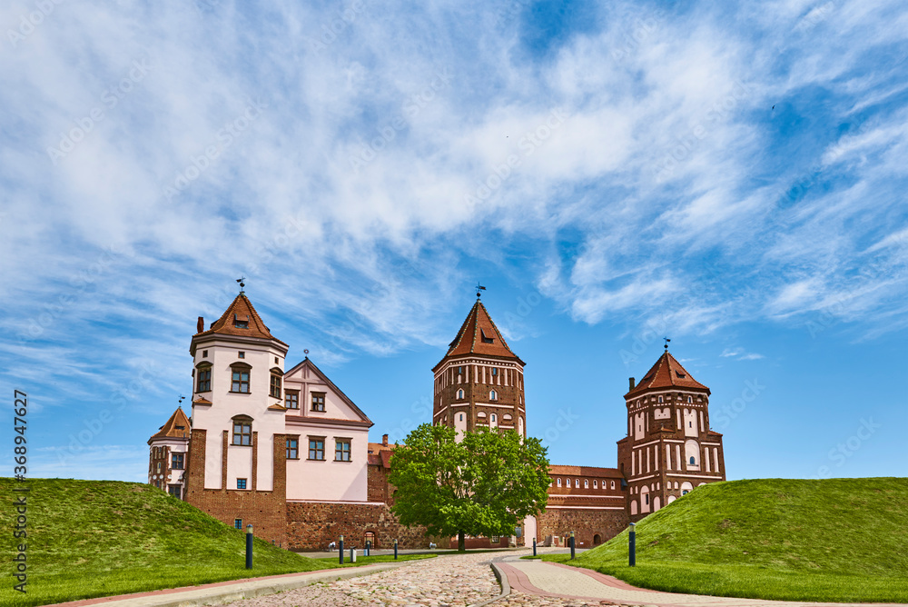 Mir castle complex in summer day with blue cloudy sky. Tourism landmark in Belarus, cultural monument