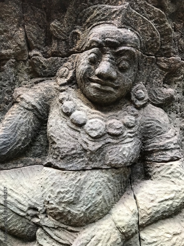 The Terrace of the Leper King has carvings of nagas (dragons), demons and various mythical beings.  You can find the Terrace of the Leper King in central Angkor Thom.  