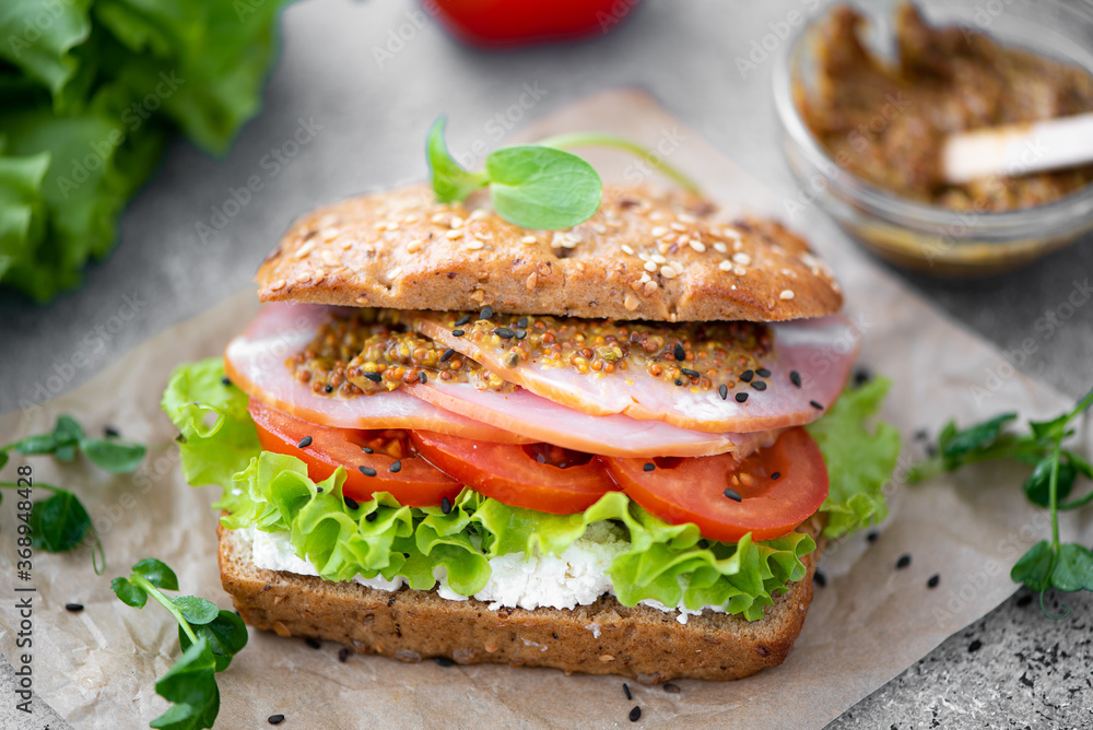 sandwich with ham, lettuce, tomato and mustard sandwich with ham, lettuce, tomato and mustard