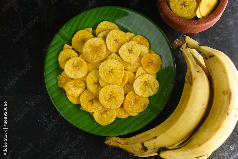 Kerala snack Banana chips or Kaya Varuthathu fried snack in terracotta
