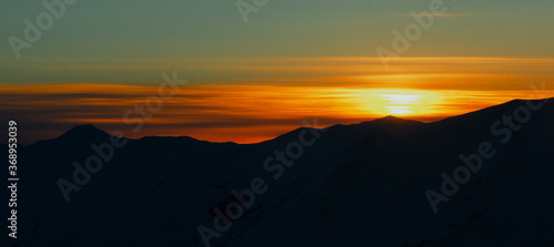 Colorful mountain sunset, sunset view from an airplane, panorama, Badzhalsky mountain range in the far East of Russia. photo