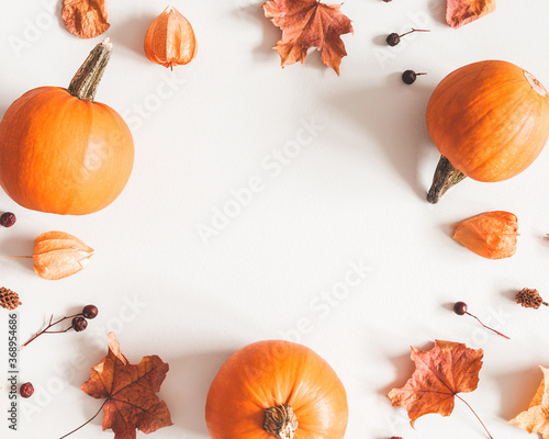 Autumn composition. Pumpkins, candles, dried leaves on white background. Autumn, fall, halloween concept. Flat lay, top view, copy space