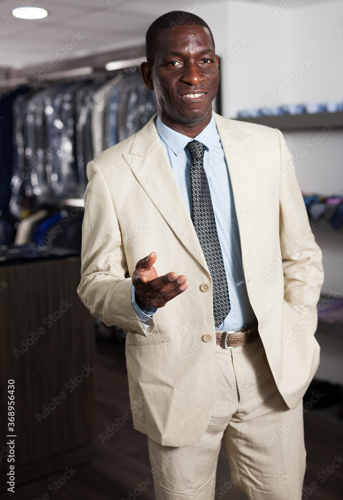 Afro-american man choosing casual jacket in fashion store. High quality photo