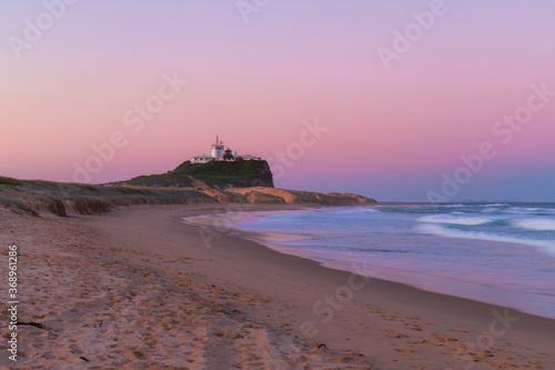 Dusk view of Nobbys lighthouse from Nobbys Beach, Newcastle, Australia.