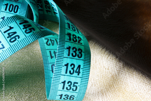 measuring tape on a fabric background
