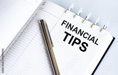 text financial tips on the short note texture background with pen