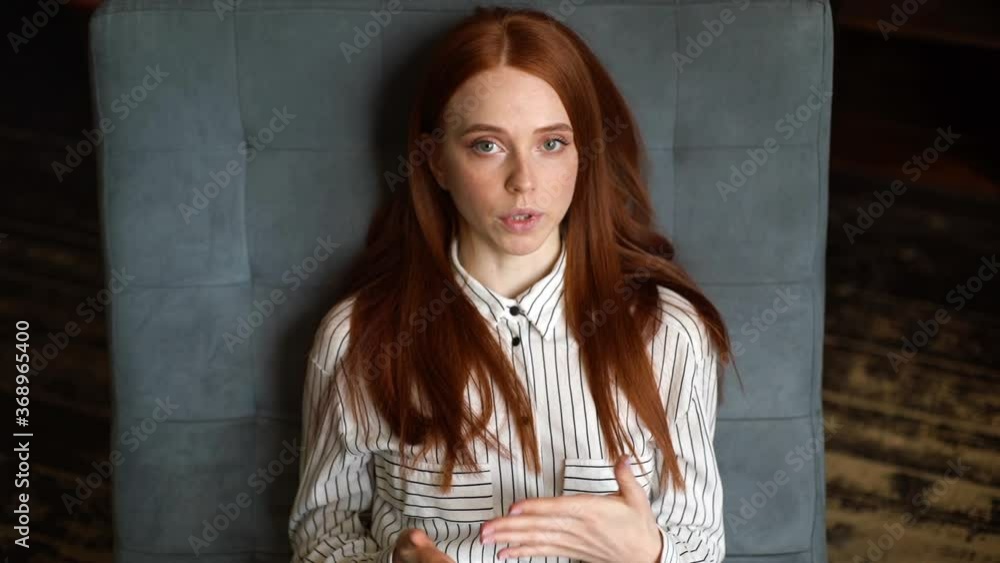 Top view of attractive red-haired young woman patient lying on comfortable armchair and telling about her problems to psychotherapist. Depressed lady speaking with doctor during counseling therapy. Top view of attractive red-haired young woman patient lying on comfortable armchair and telling about her problems to psychotherapist. Depressed lady speaking with doctor during counseling therapy.