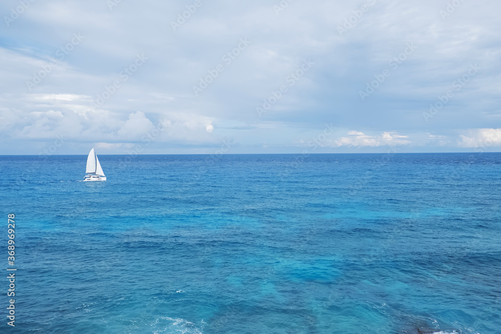 Fototapeta premium A lonely sailing boat in the sea