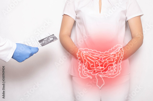 The doctor holds the results of the examination of the female patient on a white background. Bowel inflammation and disease concept, abdominal pain, cancer photo