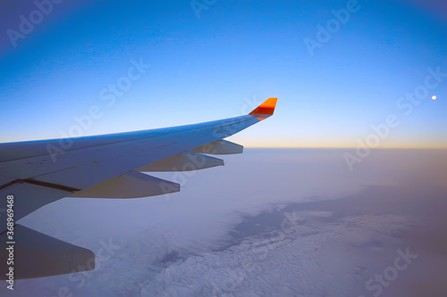 wing airplane view of sky / blue sky and wing of an airplane, view from the cabin of an airplane, concept of air transport