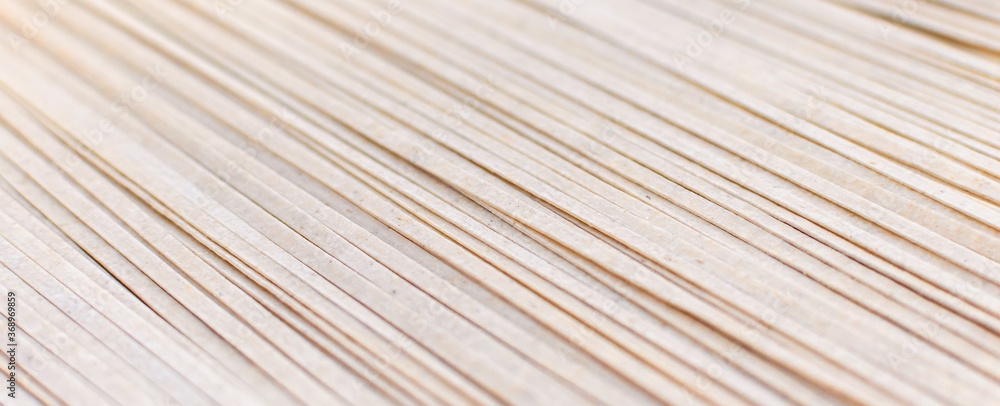 Brown soba noodles close up, top view. Asian cuisine, buckwheat pasta, raw, uncooked, natural, organic, vegetarian healthy food background. Striped surface. Banner with copy space. Brown soba noodles close up, top view. Asian cuisine, buckwheat pasta, raw, uncooked, natural, organic, vegetarian healthy food background. Striped surface. Banner with copy space.
