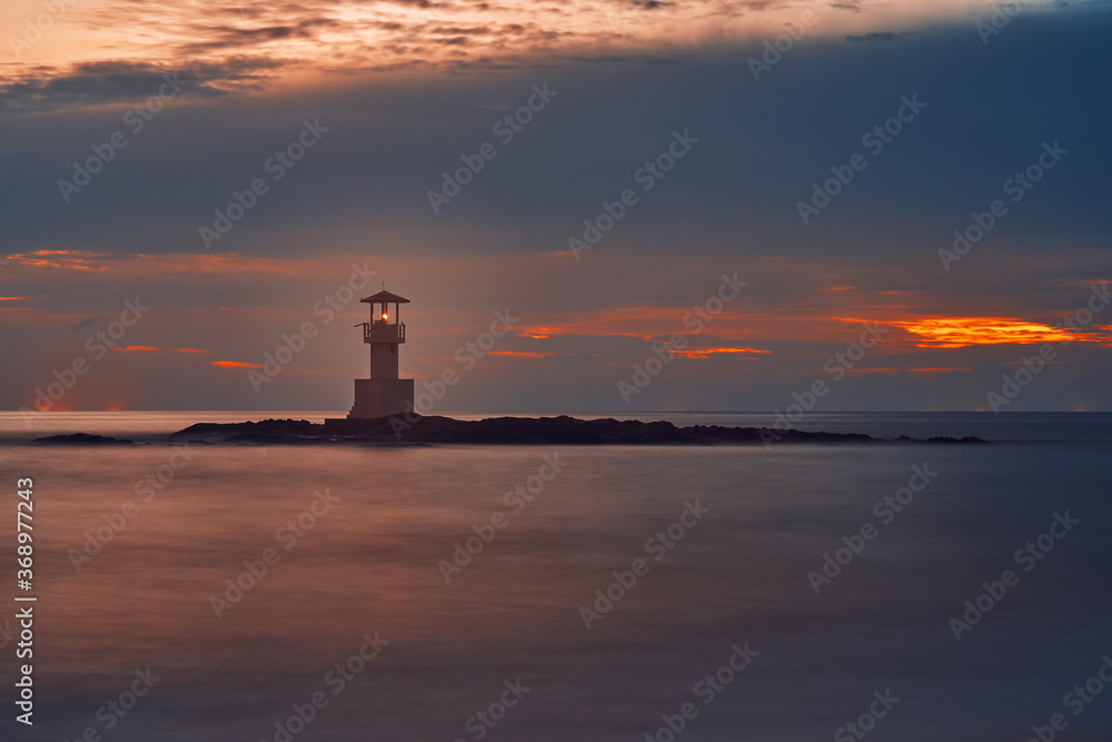 Seascape at sunset. Lighthouse on the coast. long shutter shot
