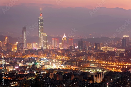 Panoramic aerial view of crowded Taipei City  Taipei landmark  XinYi Commercial District  Keelung River and downtown area at moody dusk   Taipei City skyline in evening twilight