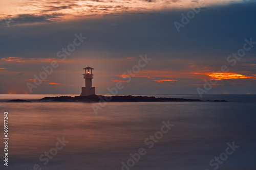 Obraz na płótnie Seascape at sunset. Lighthouse on the coast. long shutter shot w salonie