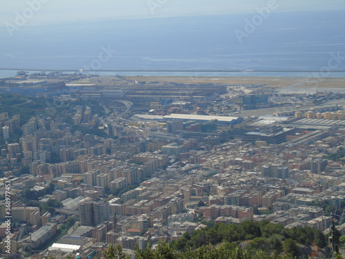 Genova, Italy – 07/30/2020: Beautiful scenic aerial view of the city, port, dam, sea, Cristoforo Colombo airport runway, containers shipping terminal, Pra, Voltri, and Sestri promontory from Monte Gaz © yohananegusse