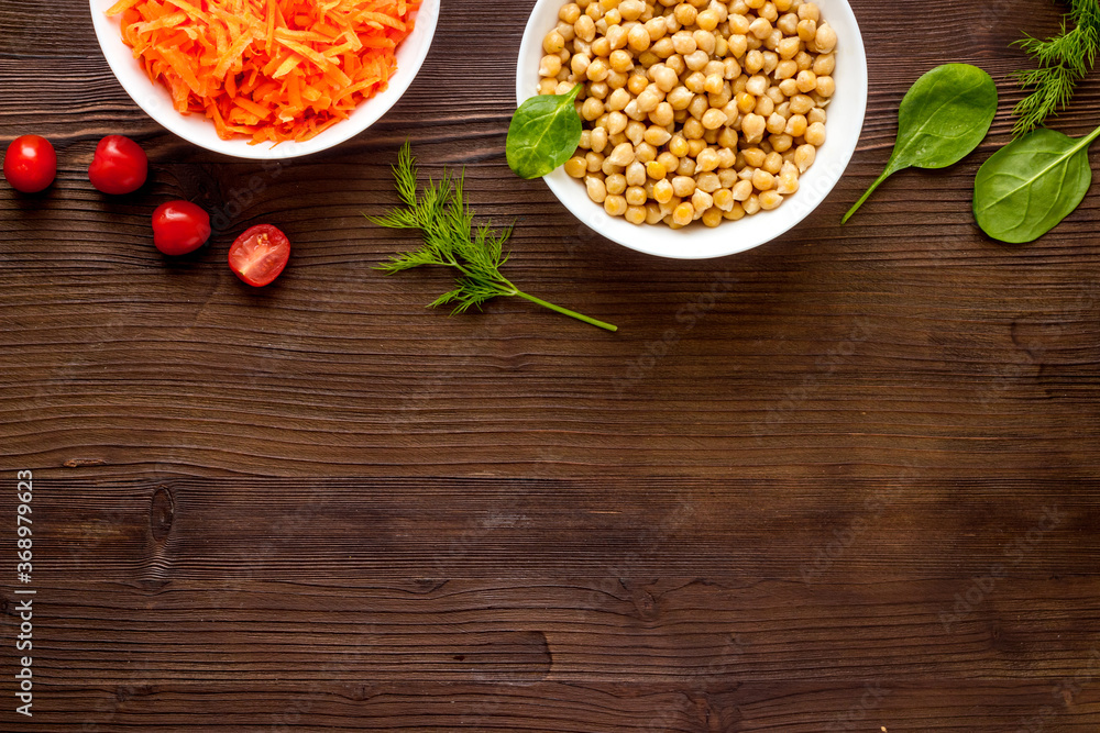 Vegetarian bowl with chickpeas and vegetables - wooden table top view copy space Vegetarian bowl with chickpeas and vegetables - wooden table top view copy space