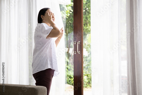 Alone old woman holding head by hand cause of headache, elder care or healthy concept