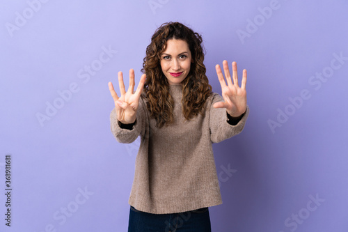 Young caucasian woman isolated on purple background counting nine with fingers