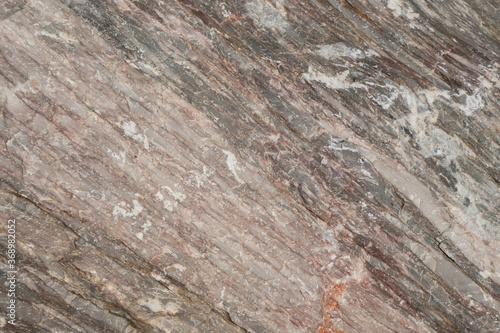 Close up view onto surface of natural karst marble, its linear inner layers