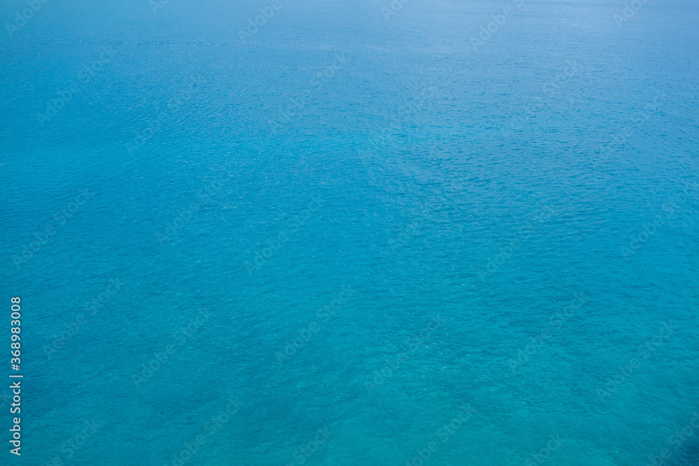 Obraz premium Blue surface of sea. Water is calm, just a little waves from breeze