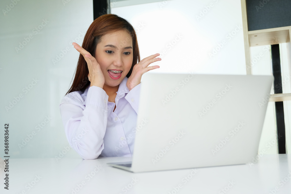 The female staff member was happy to see the sales on the computer screen. The female staff member was happy to see the sales on the computer screen.