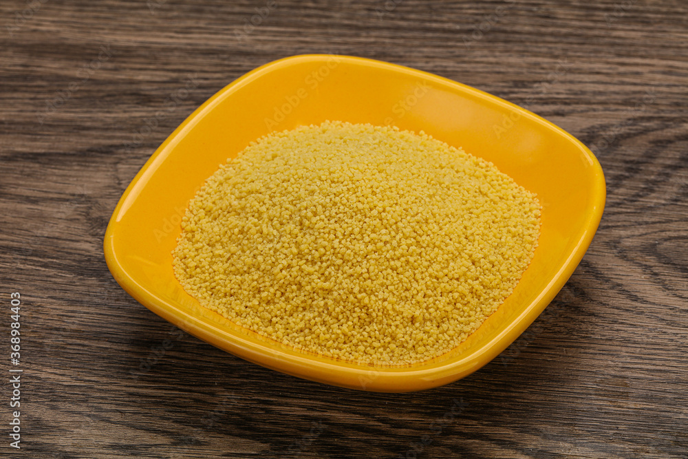 Raw cous cous heap in the bowl Raw cous cous heap in the bowl