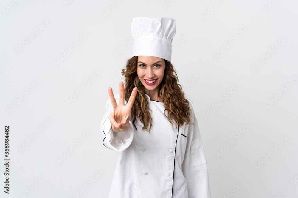 Young chef woman isolated on white background happy and counting three with fingers Young chef woman isolated on white background happy and counting three with fingers