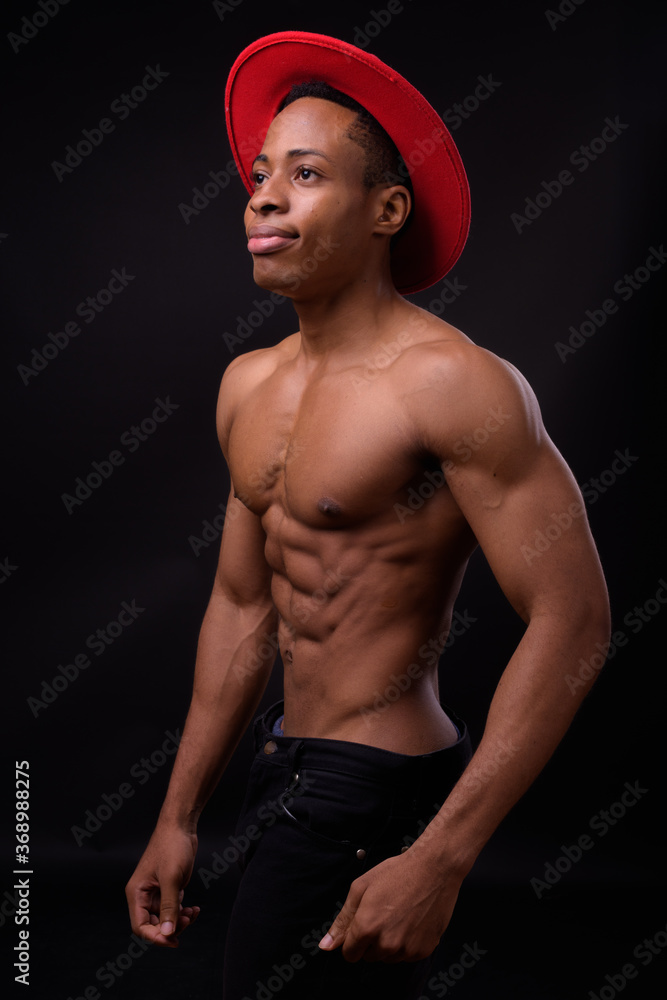Portrait of young handsome muscular African man shirtless