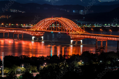 Beautiful and colorful night view of grand bridge and reflection © Chongbum Thomas Park