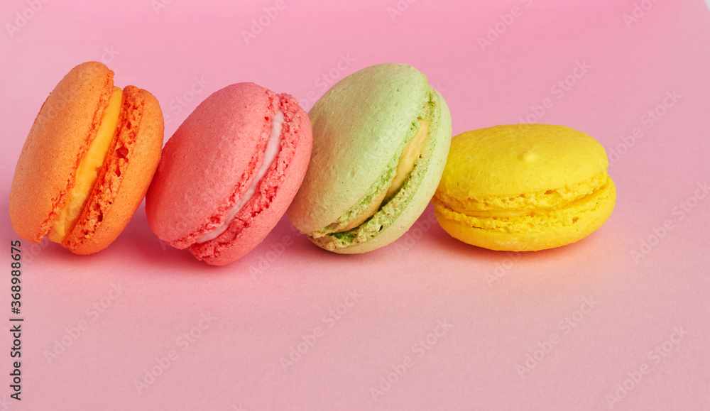 stack of baked macarons on pink background, delicious dessert made from almond flour stack of baked macarons on pink background, delicious dessert made from almond flour