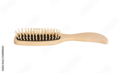 new wooden comb with handle isolated on white background