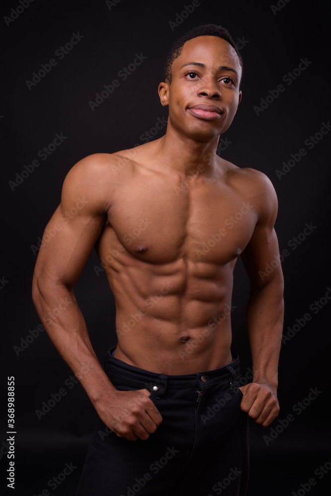 Fototapeta premium Portrait of young handsome muscular African man shirtless